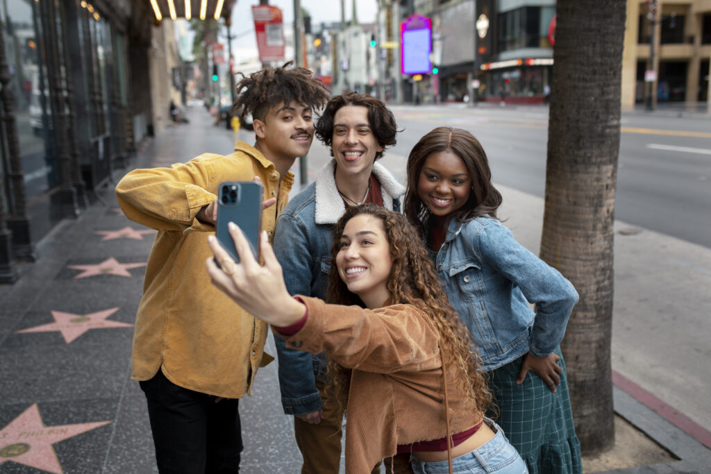 Woman taking selfie with friends while out in city