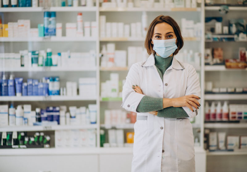 Doctor wears medical mask standing in pharmacy